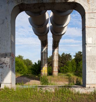 Elevated section of the pipelines with the concrete support against the sky