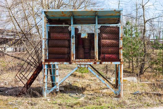 Gas cylinders in the locked storage outdoors.