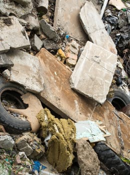 Industrial garbage. Heap of the damaged concrete blocks, old tires and other rubbish