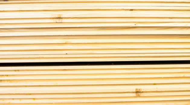 Stack of new wooden planks. Close up.