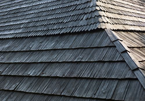Old wooden shingle roof with rich texture.