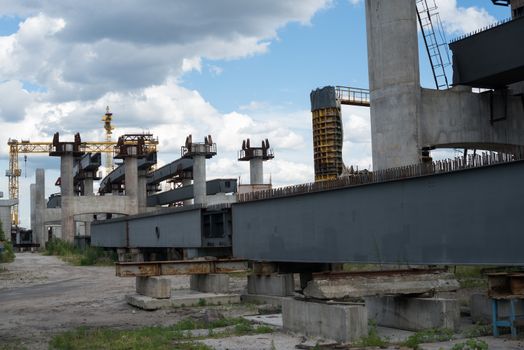 Bridge construction site with concrete piers already finished and still in the metal formwork.