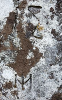 The surface of the old cross gravestone with engraved Old Church Slavonic inscriptions. Kyiv, Ukraine. Close up.