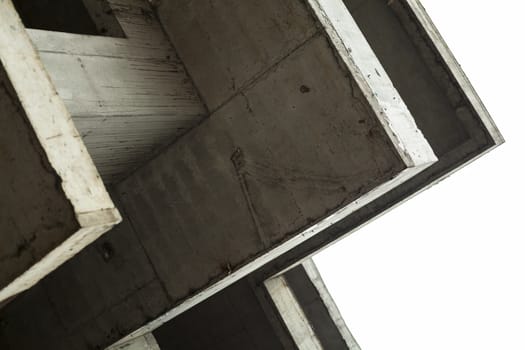 Concrete surfaces of the unfinished building against the white sky