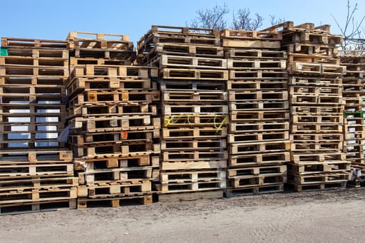 The big stack of wooden cargo pallets.