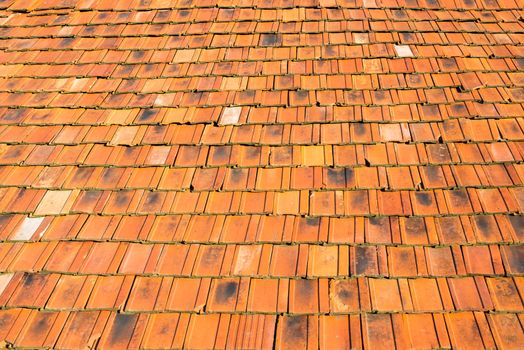 The old roof covered with orange tiles.