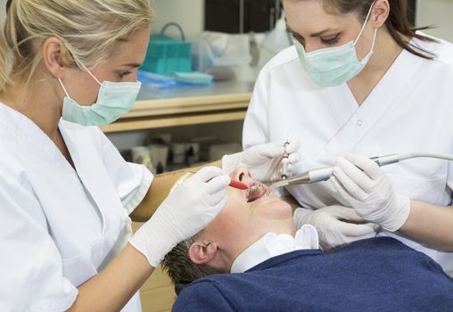 Dentist and nurse working with a patient