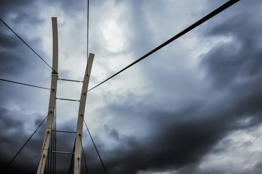 View rope bridge on the background of the cloudy sky