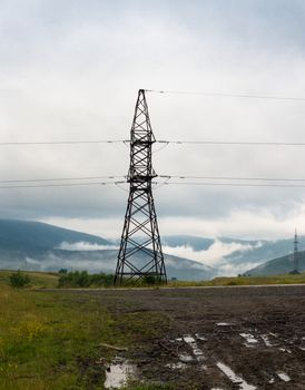 Electricity pylon against the summer landscape in the Carpathian Mountains.