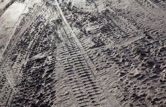 Wheel tracks on the dirt road after the rain