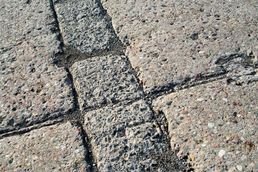 Grey concrete pavement surface with various texture