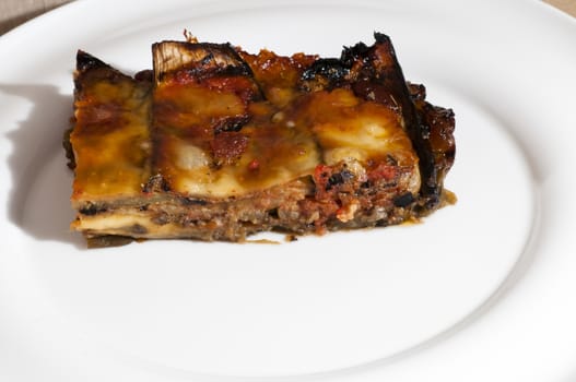 delicious eggplant parmesan served on a white plate