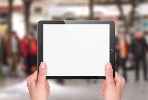 Tablet with blank screen in hand on background of street