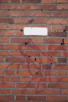 Brick wall with a white sign