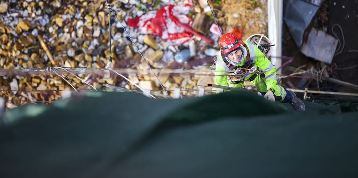 Industrial climber placing exterior advertising, view from above