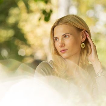 portrait of a beautiful young woman in a spring park. pictures in warm colors