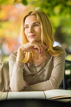 portrait of a beautiful young woman in a spring park. pictures in warm colors