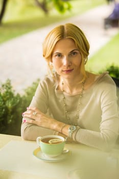 portrait of a beautiful young woman in a spring park. pictures in warm colors