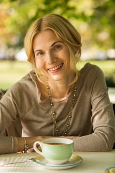 portrait of a beautiful young woman in a spring park. pictures in warm colors