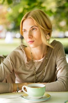 portrait of a beautiful young woman in a spring park. pictures in warm colors