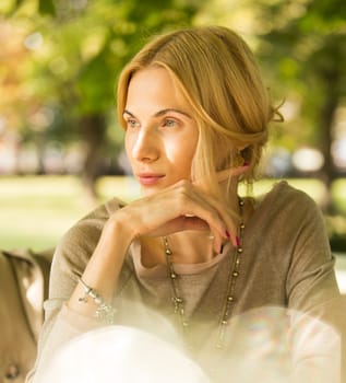 portrait of a beautiful young woman in a spring park. pictures in warm colors