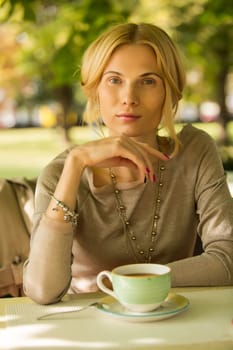 portrait of a beautiful young woman in a spring park. pictures in warm colors