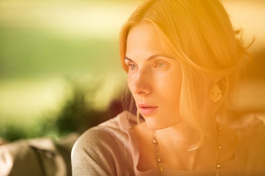 portrait of a beautiful young woman in a spring park. pictures in warm colors