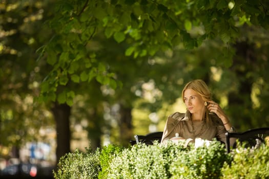 portrait of a beautiful young woman in a spring park. pictures in warm colors