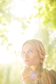 portrait of a beautiful young woman in a spring park. pictures in warm colors