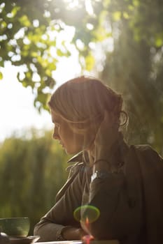 portrait of a beautiful young woman in a spring park. pictures in warm colors