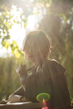 portrait of a beautiful young woman in a spring park. pictures in warm colors