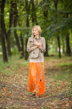 Young fashionable woman walking in spring park