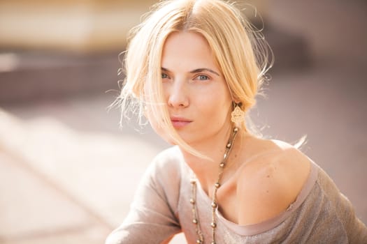 fashion portrait of a beautiful young woman on city background