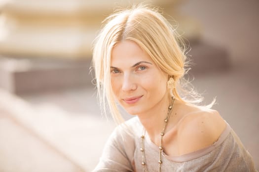 fashion portrait of a beautiful young woman on city background