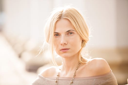 fashion portrait of a beautiful young woman on city background