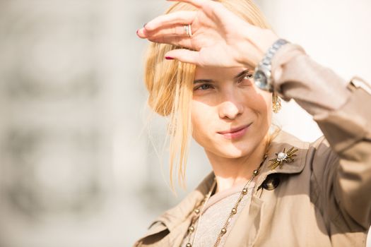 fashion portrait of a beautiful young woman on city background