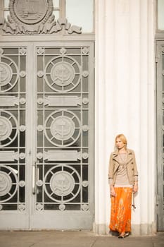 fashion portrait of a beautiful young woman on city background