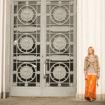 fashion portrait of a beautiful young woman on city background