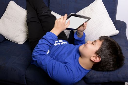 Child uses an iPad to communicate and play.