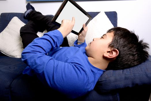 Child uses an iPad to communicate and play.