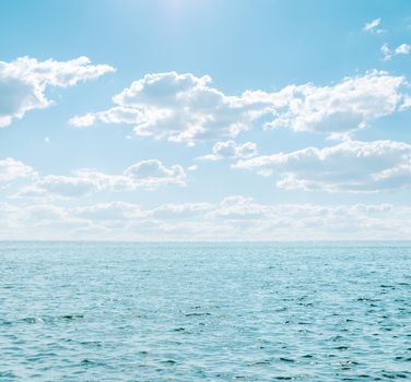 light blue sea and cloudy sky