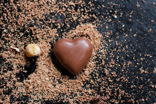 Chocolate heart in chocolate chips on a black background