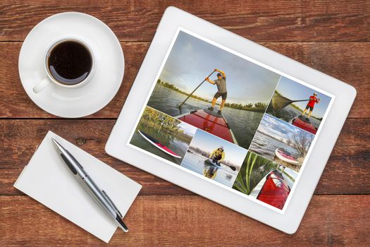 reviewing pictures of stand up paddling featuring a senior male on a digital tablet with a cup of coffee. All screen pictures copyright by the photographer with the same model (self).