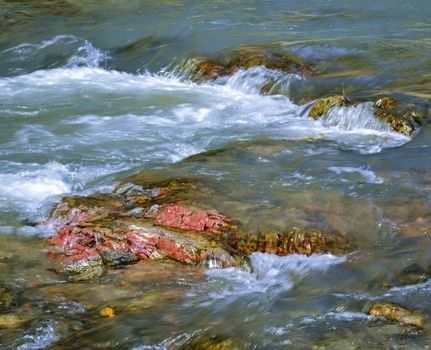 abstract background or nature scene red stone in a wild river
