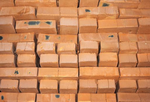 Background of many red bricks for construction in a pallet