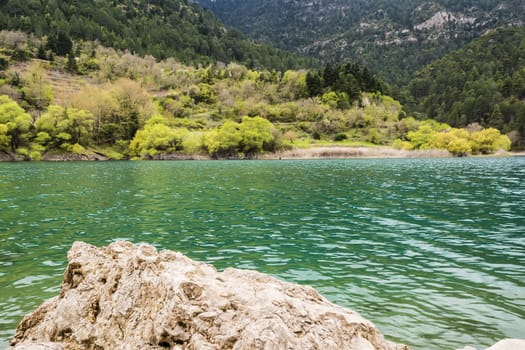 Mountain green lake view with rock