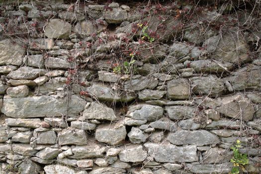 Old shabby wall of large hewn stones