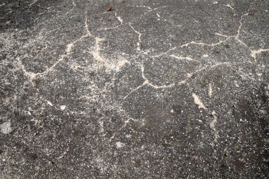 Detail of an old cracked asphalt road