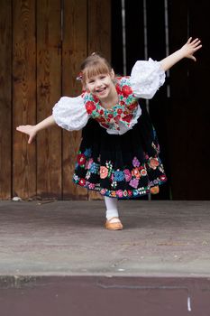 Smiling, happy little girl in traditional costume