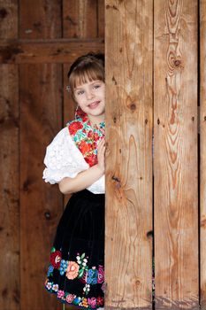 Smiling, happy little girl in traditional costume